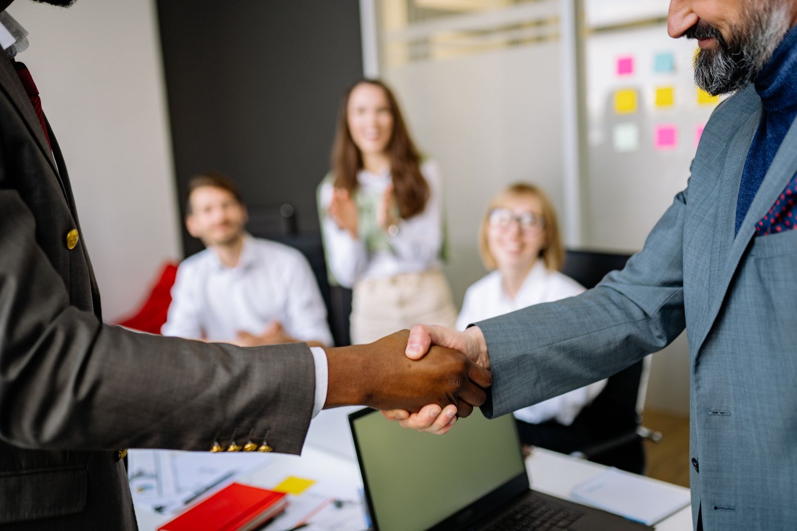 Business partnership handshake in a professional office setting